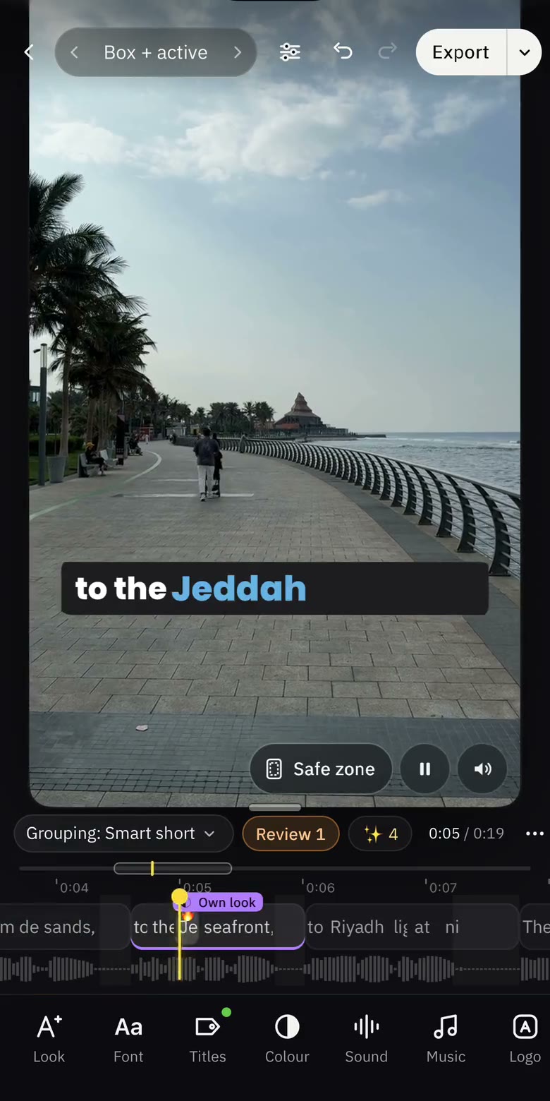 The Moticap editor on iPhone: a boxed caption on the video, the timeline and tools below it
